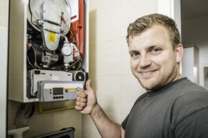 Repair Man Fixing Faulty Furnace